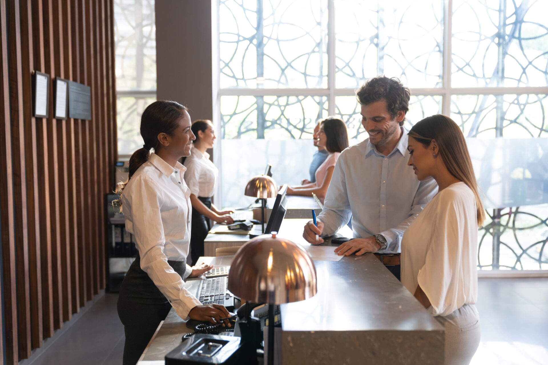 People at a hotel enjoying their vacation checking in filling a form